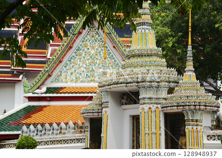Classic Thai architecture with pagoda in Wat Phra Chetuphon or Wat Pho. Which is one of the largest and oldest temples and is popular with both Thai and foreign tourists. Classic Thai architecture with pagoda in Wat Phra Chetuphon or Wat Pho. Which is one of the largest and oldest temples and is popular with both Thai and foreign tourists. 128948937