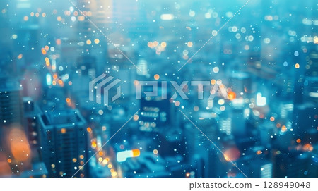 A blurred and grainy cityscape bathed in a cool blue light. The lights of the city seem to dance and flicker creating a sense of motion and energy in an otherwise still and quiet scene 128949048