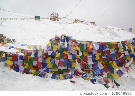 Prayer flags at a small religious site at Khardung La. This pass is located in the Ladakh mountains north of Leh and connects the Indus and Shyok river valleys and is the highest motorable road. Prayer flags at a small religious site at Khardung La. This pass is located in the Ladakh mountains north of Leh and connects the Indus and Shyok river valleys and is the highest motorable road. 128949532