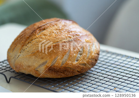 Freshly Baked Sourdough Bread Cooling on a Wire 128950136