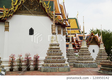 Classic Thai architecture with pagoda in Wat Phra Chetuphon or Wat Pho. Which is one of the largest and oldest temples and is popular with both Thai and foreign tourists. Classic Thai architecture with pagoda in Wat Phra Chetuphon or Wat Pho. Which is one of the largest and oldest temples and is popular with both Thai and foreign tourists. 128950142