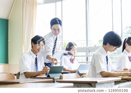 A male teacher teaching a male student 128950198