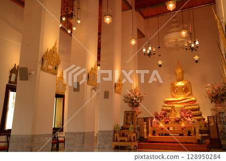The golden sitting Buddha statue is made of bronze and is enshrined in Wat Phra Chetuphon Wimonmangklaram or Wat Pho is popular with both Thai and foreign tourists. At Bangkok capital city in Thailand The golden sitting Buddha statue is made of bronze and is enshrined in Wat Phra Chetuphon Wimonmangklaram or Wat Pho is popular with both Thai and foreign tourists. At Bangkok capital city in Thailand 128950284