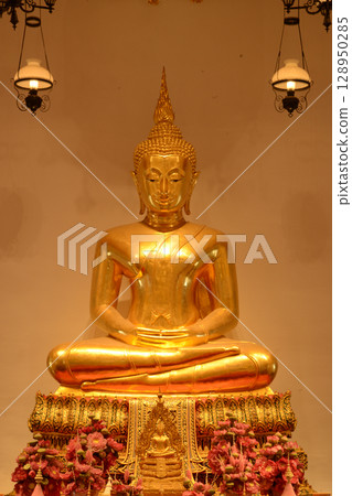 The golden sitting Buddha statue is made of bronze and is enshrined in Wat Phra Chetuphon Wimonmangklaram or Wat Pho is popular with both Thai and foreign tourists. At Bangkok capital city in Thailand The golden sitting Buddha statue is made of bronze and is enshrined in Wat Phra Chetuphon Wimonmangklaram or Wat Pho is popular with both Thai and foreign tourists. At Bangkok capital city in Thailand 128950285