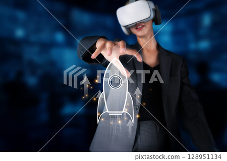 Business Professional in Virtual Reality Holding a Rocket Icon for Startup Success and Innovative Growth in a Technological Environment XDMCP 128951134