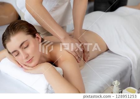 Caucasian couple customer enjoying relaxing anti-stress massage. Quiescent 128951253