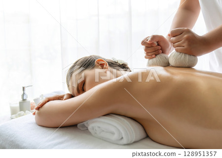 Hot herbal ball spa massage body treatment at day spa . Quiescent Hot herbal ball spa massage body treatment at day spa . Quiescent 128951357