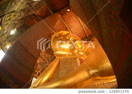 The Reclining Buddha Gold Statue. This Buddha is 46 m long and 15 m highest is located in Wat Pho Bangkok. There are many Buddhists and tourists who come to visit. 128951370