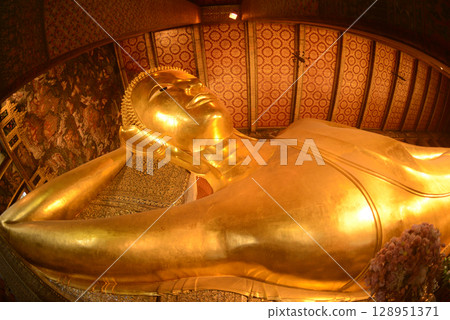 The Reclining Buddha Gold Statue. This Buddha is 46 m long and 15 m highest is located in Wat Pho Bangkok. There are many Buddhists and tourists who come to visit. The Reclining Buddha Gold Statue. This Buddha is 46 m long and 15 m highest is located in Wat Pho Bangkok. There are many Buddhists and tourists who come to visit. 128951371