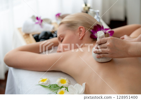 Hot herbal ball spa massage body treatment at day spa . Quiescent Hot herbal ball spa massage body treatment at day spa . Quiescent 128951400