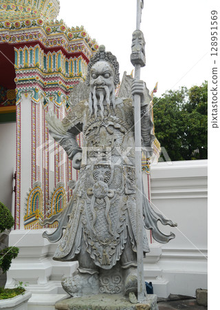 Chinese guardian statue at the gate of Wat Pho Which is one of the largest and oldest temples in Bangkok and is popular with both Thai and foreign tourists. 128951569