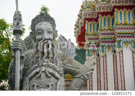 Chinese guardian statue at the gate of Wat Pho Which is one of the largest and oldest temples in Bangkok and is popular with both Thai and foreign tourists. 128951571