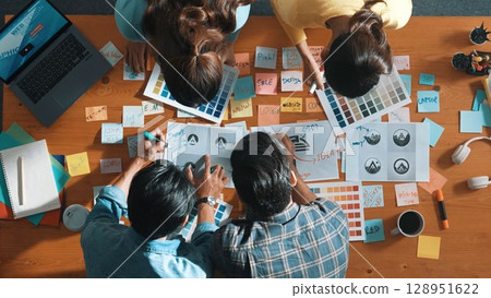 Top view of smart business team write graphic logo on meeting table. Symposium. Top view of smart business team write graphic logo on meeting table. Symposium. 128951622