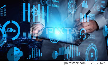 Hands of a business professional interacting with a futuristic tablet displaying data analytics and charts in a modern office setting at night xenic Hands of a business professional interacting with a futuristic tablet displaying data analytics and charts in a modern office setting at night xenic 128951624