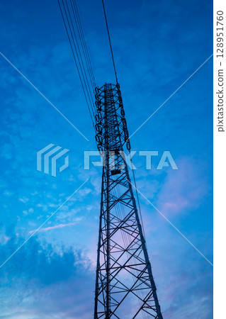 Power line tower seen in the evening sky: cool colors 128951760