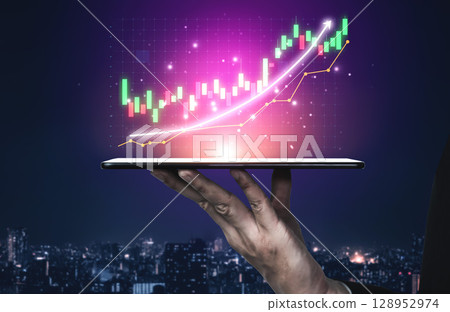 Digital Tablet Displaying Financial Graph with Rising Trend in Night Cityscape Background for Investment and Finance Concepts Impute 128952974