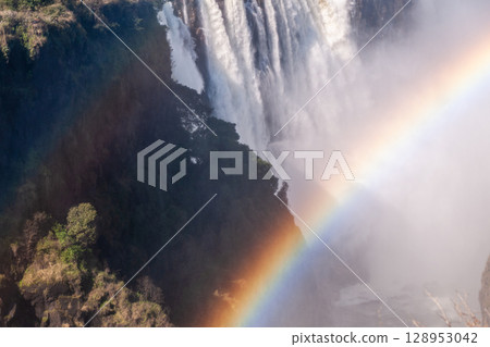 Close up of a rainbow over victoria falls Close up of a rainbow over victoria falls 128953042