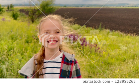 Blissful Smiles, Sun Behind Clouds, Innocence Outdoors, Childhood Delight, Golden Light, Fresh Air, Playful Smile, Bright Day, Free and Happy, Open Fields, Happy Girl Portrait, Sunlit Hair, Bright 128953265