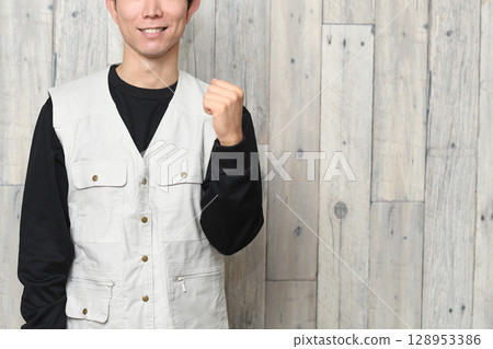 Asian male worker wearing helmet and work clothes 128953386