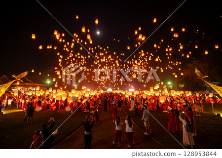 Fire Lanterns Floating up into the sky at night at Loi Krathong Festival Travel Destinations Of Chiang Mai, Thailand. Fire Lanterns Floating up into the sky at night at Loi Krathong Festival Travel Destinations Of Chiang Mai, Thailand. 128953844