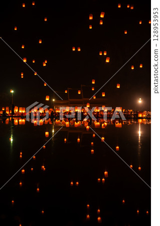 Fire Lanterns Floating up into the sky is reflection in the water at night at Loi Krathong Festival Travel Destinations Of Chiang Mai, Thailand. Fire Lanterns Floating up into the sky is reflection in the water at night at Loi Krathong Festival Travel Destinations Of Chiang Mai, Thailand. 128953953