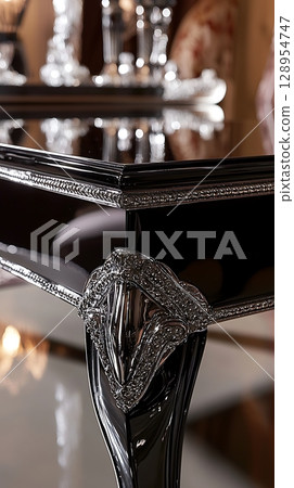A black table with a silver design on it 128954747