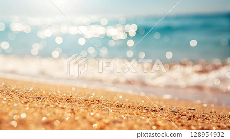 A close-up shot shows golden sand meeting the blurred turquoise sea, with bokeh effects adding a dreamy, sun-kissed quality to the tranquil beach 128954932