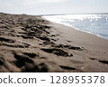 Waves crashing on the sandy beach, the Sea of Japan in midsummer 128955378