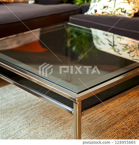 A glass coffee table with a plant on top of it 128955665