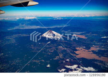 A spectacular view of snow-capped clouds and a beautiful sea of clouds covered in snow as seen from an airplane A spectacular view of snow-capped clouds and a beautiful sea of clouds covered in snow as seen from an airplane 128956190
