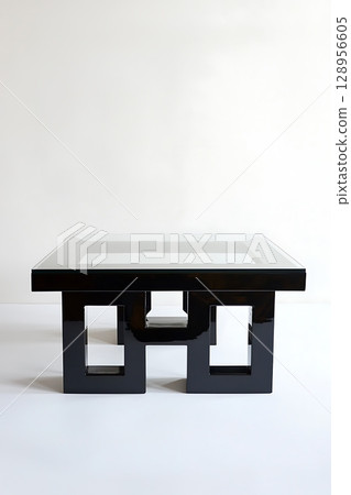 Black table with a glass top and a white background 128956605
