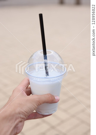 Enjoying a Refreshing Beverage in Hand While Relaxing on a Beautiful Sunny Day Outside 128956822