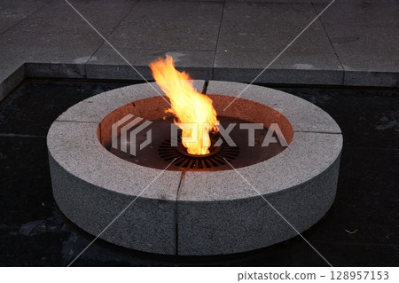 Eternal Flame beautifully set within a Circular Stone Base, honoring memory and tradition 128957153