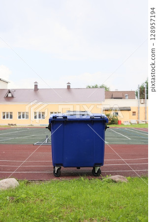 The Blue Trash Bin is prominently located on the Sports Field adjacent to the School Building 128957194