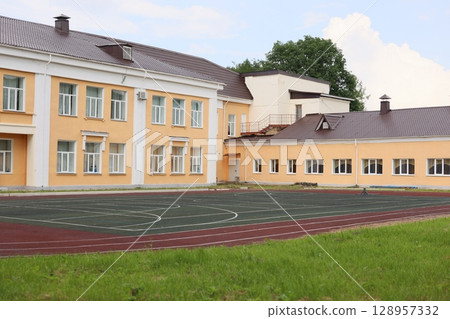 A Modern School Building featuring a Sports Field and lush Green Surroundings for all 128957332
