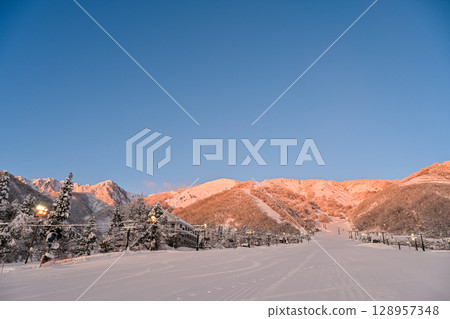 A beautiful ski resort bathed in the morning sun 128957348