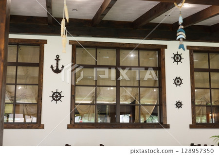 Experience the Cozy and Inviting Interior Featuring Nautical Theme Decor and Expansive Large Windows Experience the Cozy and Inviting Interior Featuring Nautical Theme Decor and Expansive Large Windows 128957350