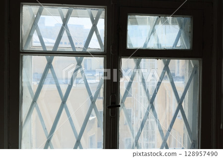 Exploring Geometric Window Design Featuring an Intricate Cross Pattern for Aesthetic Appeal 128957490