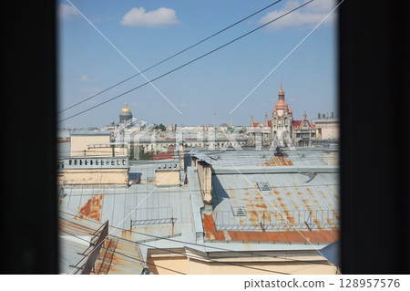 A stunning city rooftop view showcasing historic architecture brilliantly under a clear blue sky A stunning city rooftop view showcasing historic architecture brilliantly under a clear blue sky 128957576