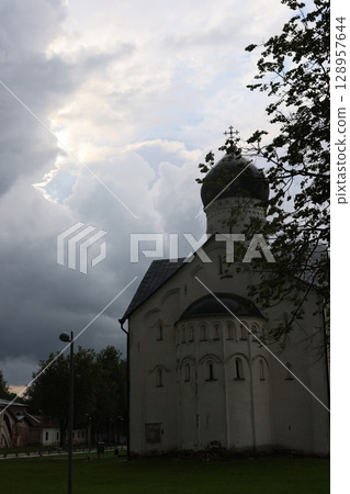A Historic Church Surrounded Beautifully by a Dramatic Sky and Lush Nature All Around A Historic Church Surrounded Beautifully by a Dramatic Sky and Lush Nature All Around 128957644