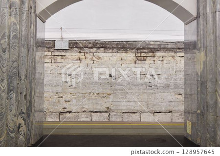 An Abandoned Subway Station with Weathered Walls, Arched Entryways, and Gritty Atmosphere 128957645