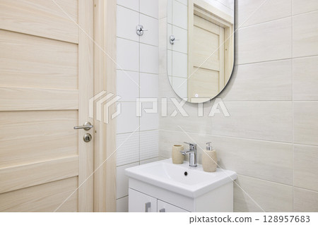 A Modern Bathroom featuring a Minimalist Design complemented by Elegant and Stylish Fixtures A Modern Bathroom featuring a Minimalist Design complemented by Elegant and Stylish Fixtures 128957683