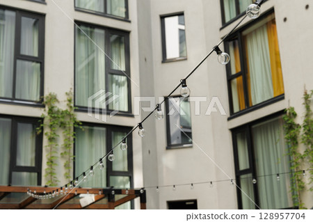 Explore Modern Architectural Details Coupled with Cozy Outdoor Lighting for a Perfect Ambiance 128957704