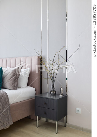 Stylish Bedroom Nightstand Featuring Modern Decor Elements for a Trendy Look and Feel 128957709