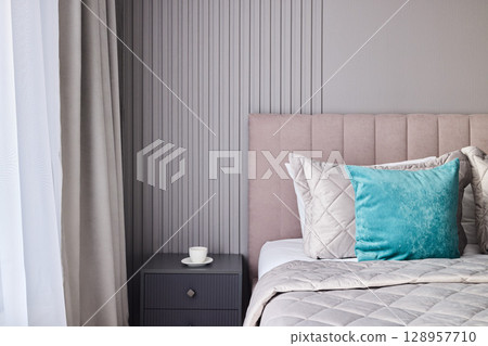 An Elegant and Inviting Bedroom Design Featuring Soft Textures Alongside Colorful Accents An Elegant and Inviting Bedroom Design Featuring Soft Textures Alongside Colorful Accents 128957710