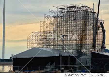 The Current Progress of Construction on a Modern Buildings Framework During Sunset Hours 128957830