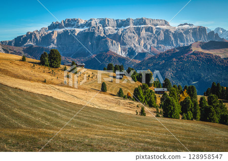 Autumn scenery and beautiful snowy mountain peaks in the Dolomites Autumn scenery and beautiful snowy mountain peaks in the Dolomites 128958547