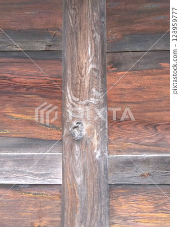 The sun-scorched wooden walls and columns of the temple gate The sun-scorched wooden walls and columns of the temple gate 128959777