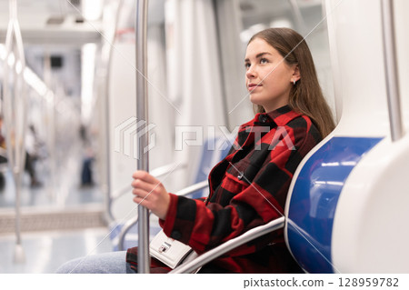 Girl sit in tram car, getting to work 128959782