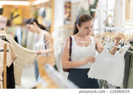 woman chooses stylish summer clothes woman chooses stylish summer clothes 128960035